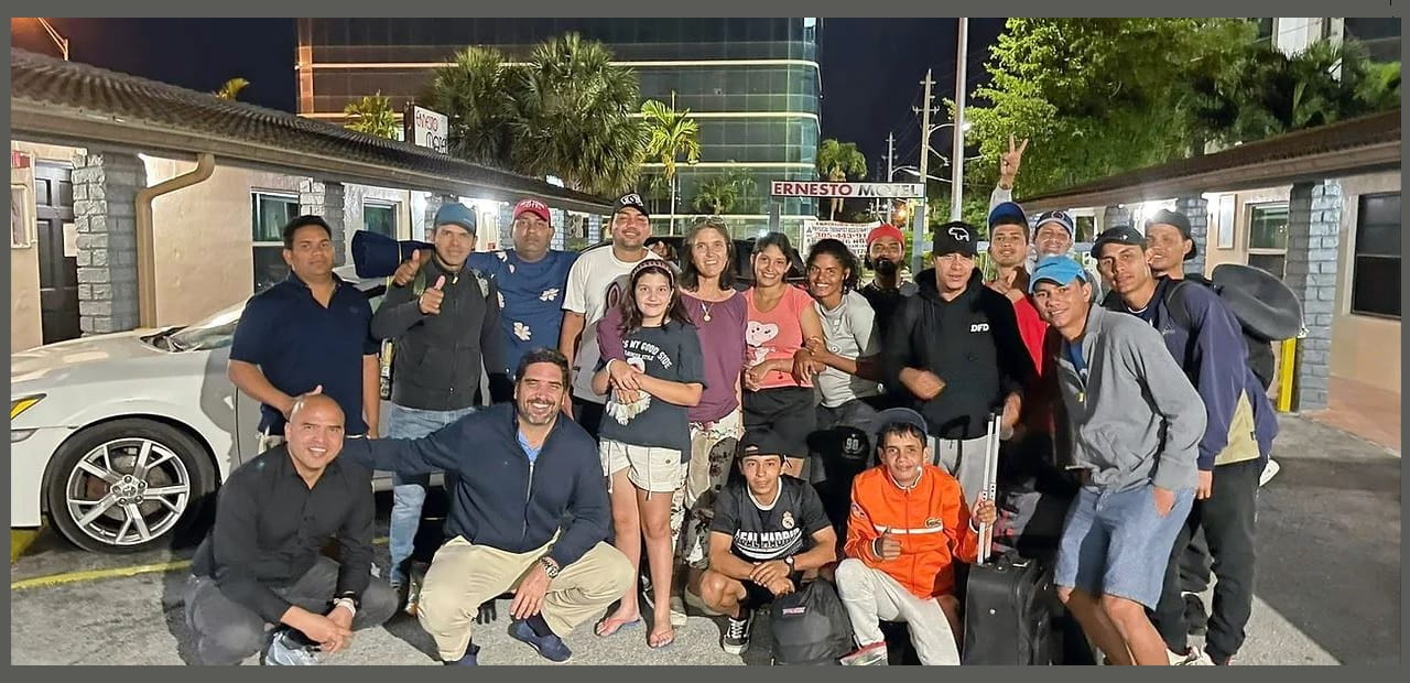 Volunteers and residents pose together in a parking lot
