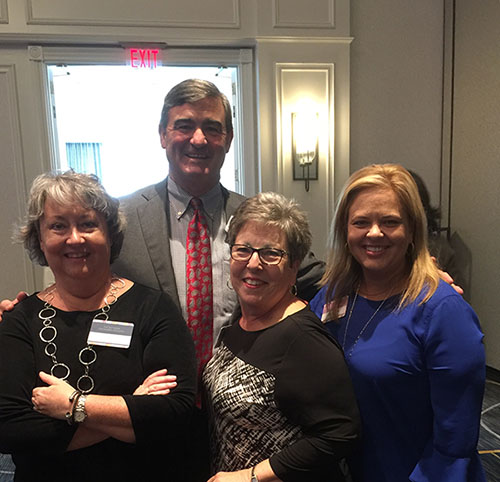 Suzanne Bradford, Freda Evans and Lisa Gamble enjoyed visiting with Division Director, Dick Ferguson at the 2018 Women's Symposium