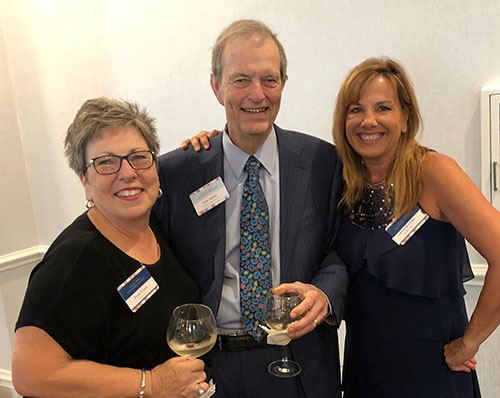 Freda Evans visits with Tom James at the Women's Symposium Cocktail Reception